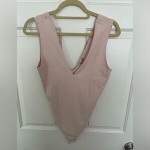 Free People V-neck thong bodysuit in a baby pink color